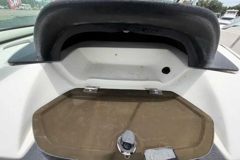 Slide: The Image of Storage compartment on a 2007 Sea Ray SLX 250 boat, featuring a latch and black trim. - 60