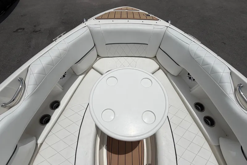 Slide: The Image of 2007 Sea Ray SLX 250 boat interior with white seating and round table. - 41