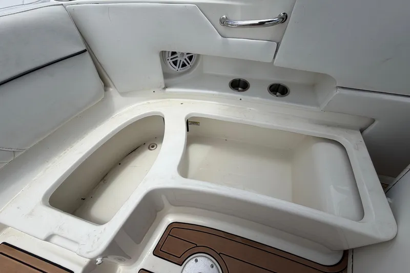 Slide: The Image of Interior view of a 2007 Sea Ray SLX 250 boat, featuring seating and deck details. - 68