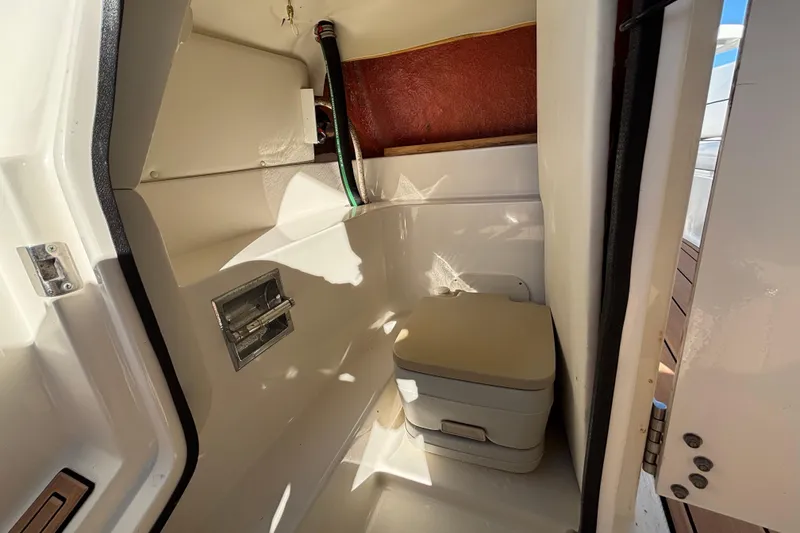 Slide: The Image of 2007 Sea Ray SLX 250 boat interior with compact marine toilet. - 65