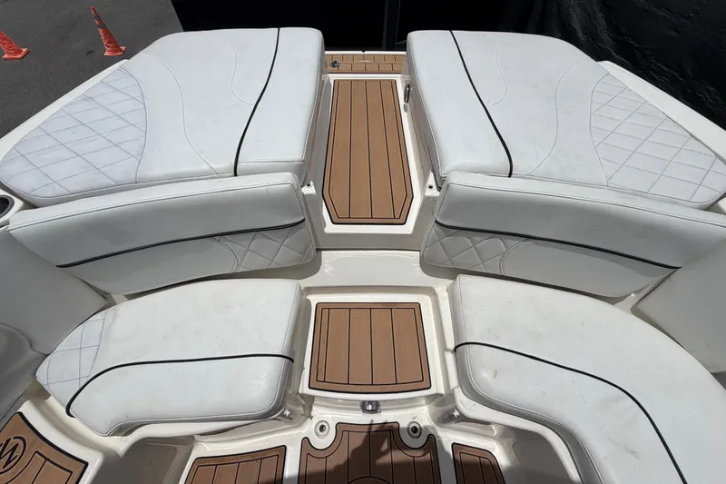 Slide: The Image of 2007 Sea Ray SLX 250 boat interior with white cushioned seating and teak flooring. - 73