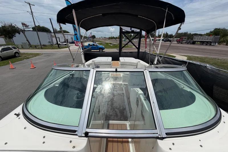 Slide: The Image of 2007 Sea Ray SLX 250 boat with canopy, parked on a lot. - 54