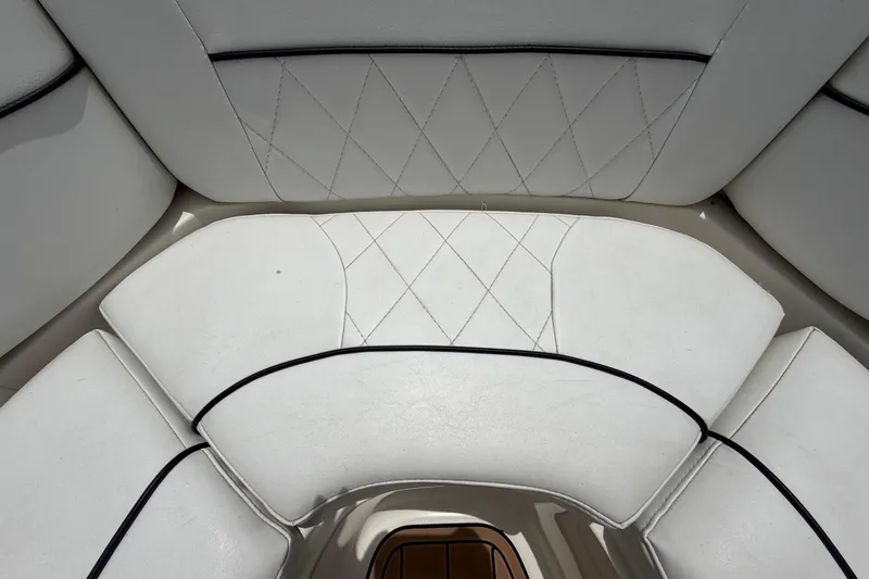 Slide: The Image of 2007 Sea Ray SLX 250 boat interior with white cushioned seating and diamond stitching. - 49