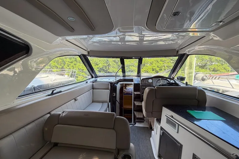 Slide: The Image of Interior of 2015 Regal 38 Express yacht, featuring seating and helm station. - 19