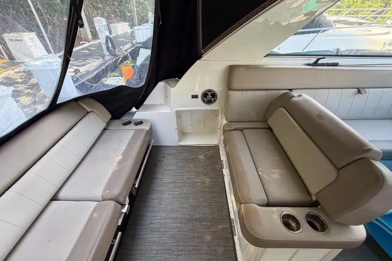 Slide: The Image of 2015 Regal 38 Express yacht interior with beige seating and cup holders. - 77