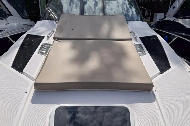 Slide: The Image of 2015 Regal 38 Express boat with sunpad on deck, featuring sleek design and modern amenities. - 38