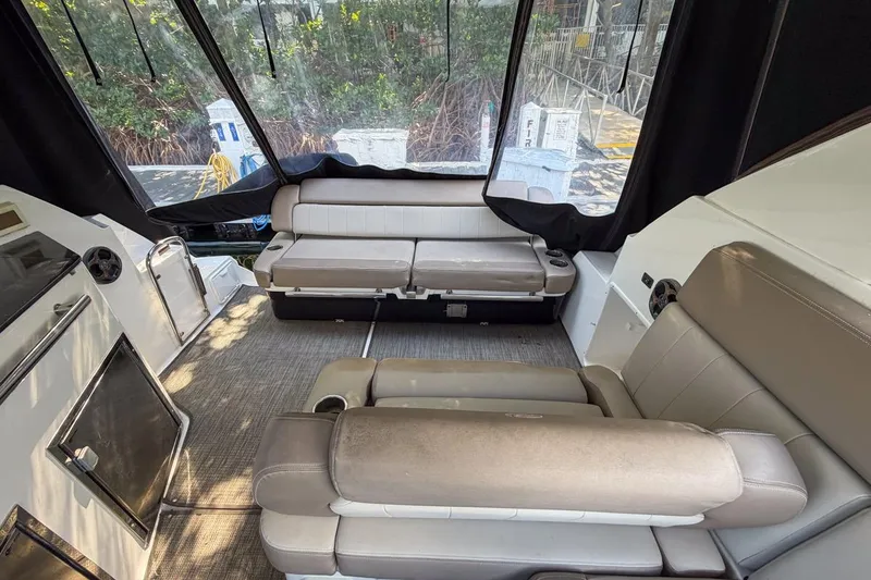 Slide: The Image of Interior of 2015 Regal 38 Express yacht with beige seating and large windows. - 48