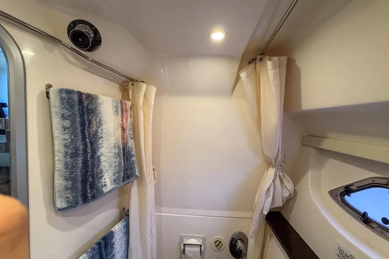 Slide: The Image of Bathroom interior of 2015 Regal 38 Express yacht with towels and porthole. - 94