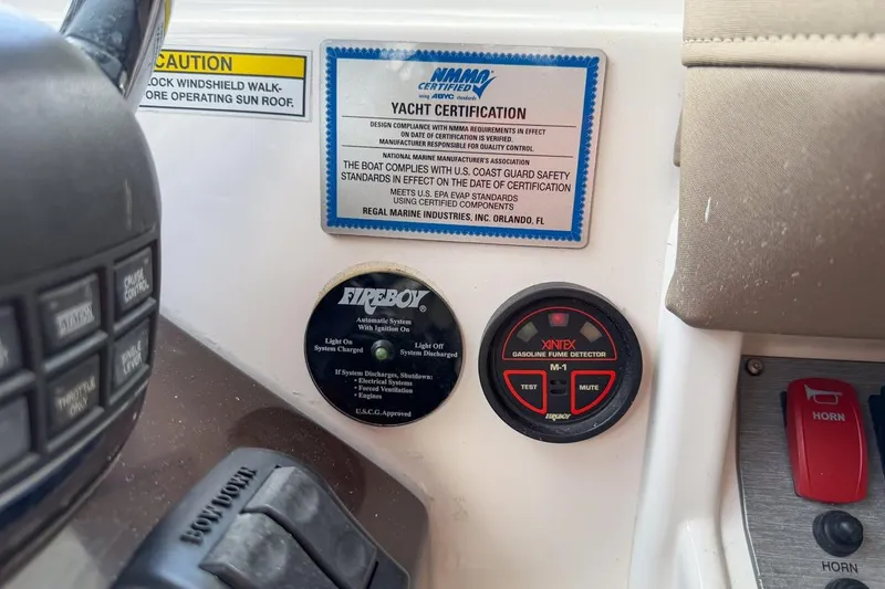 Slide: The Image of Control panel of a 2015 Regal 38 Express yacht with safety certifications. - 60