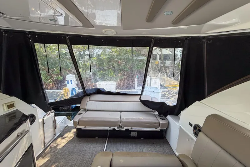 Slide: The Image of Interior of 2015 Regal 38 Express yacht with seating and windows. - 49