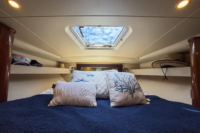 Slide: The Image of Cozy cabin interior of 2015 Regal 38 Express yacht with skylight and decorative pillows. - 82
