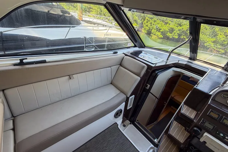Slide: The Image of Interior of 2015 Regal 38 Express yacht with seating and control panel. - 65