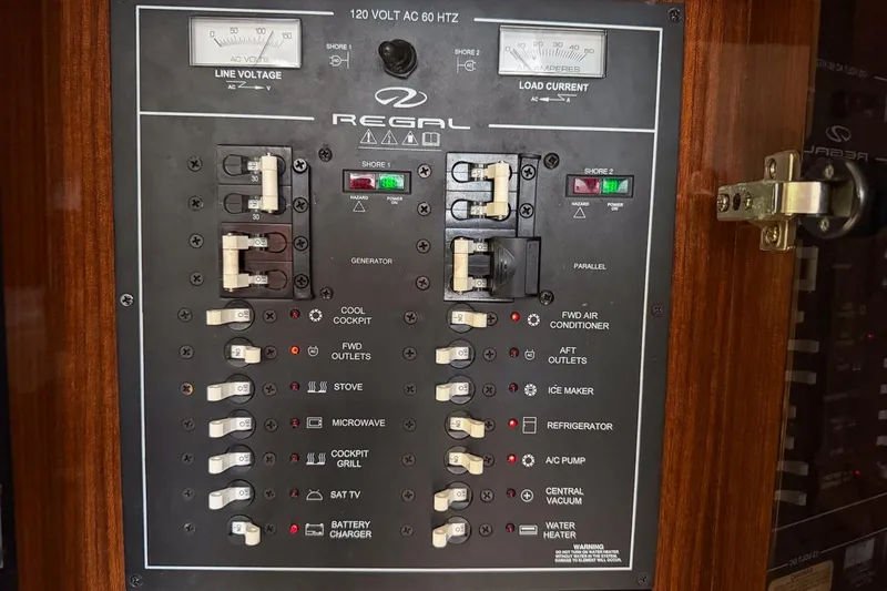 Slide: The Image of Electrical control panel of a 2015 Regal 38 Express boat, featuring various switches and indicators. - 120