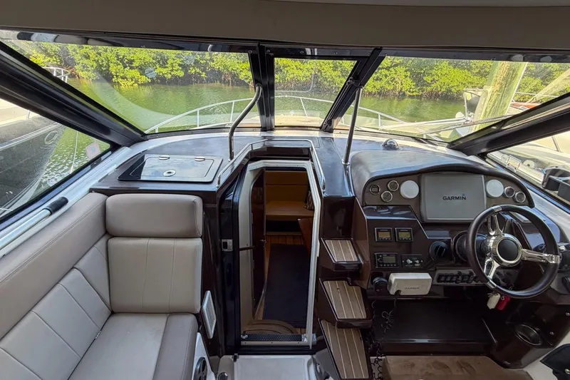 Slide: The Image of 2015 Regal 38 Express yacht interior with helm, seating, and navigation equipment. - 22