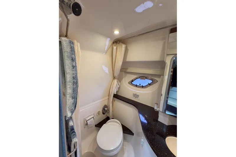 Slide: The Image of Bathroom interior of 2015 Regal 38 Express yacht with modern fixtures and porthole window. - 90