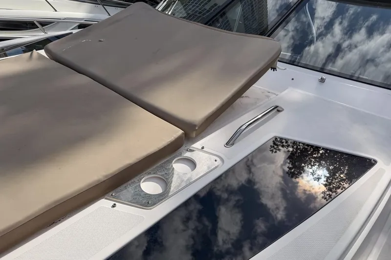 Slide: The Image of 2015 Regal 38 Express boat deck with cushioned seating and cup holders. - 41