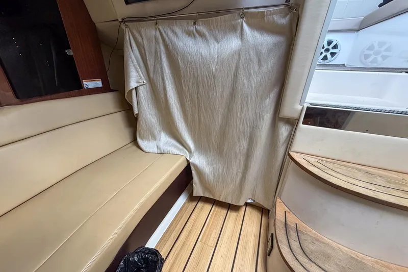 Slide: The Image of Interior of 2015 Regal 38 Express yacht with beige seating and wooden flooring. - 110