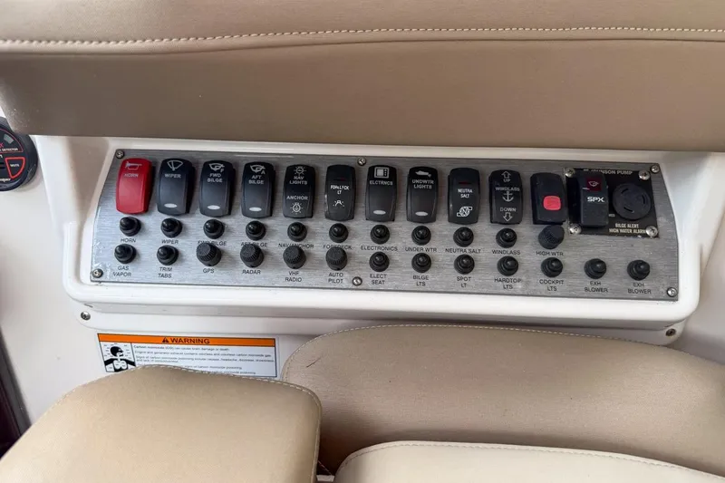 Slide: The Image of Control panel of a 2015 Regal 38 Express boat with labeled switches and buttons. - 62