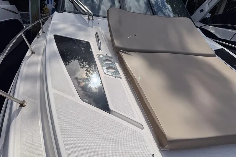 Slide: The Image of 2015 Regal 38 Express boat deck with sunpad and stainless steel railings. - 40