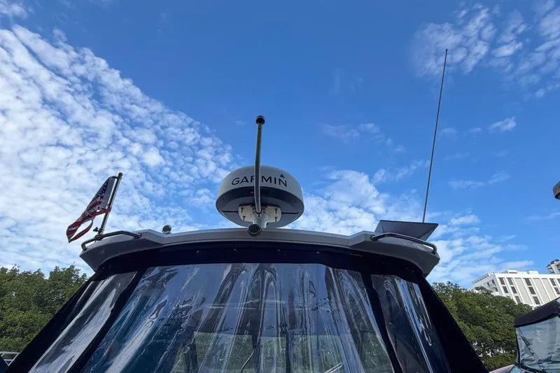Slide: The Image of 2015 Regal 38 Express boat with Garmin radar, clear sky background. - 15