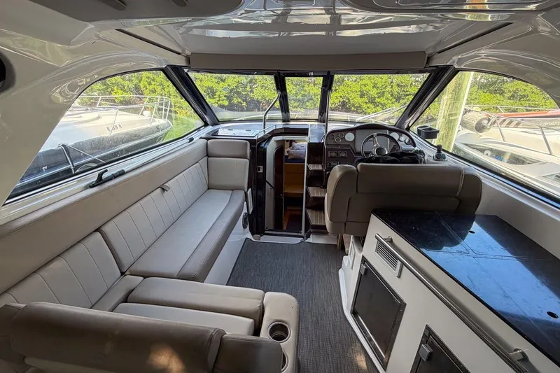 Slide: The Image of Interior of 2015 Regal 38 Express yacht with seating, helm, and kitchenette. - 17