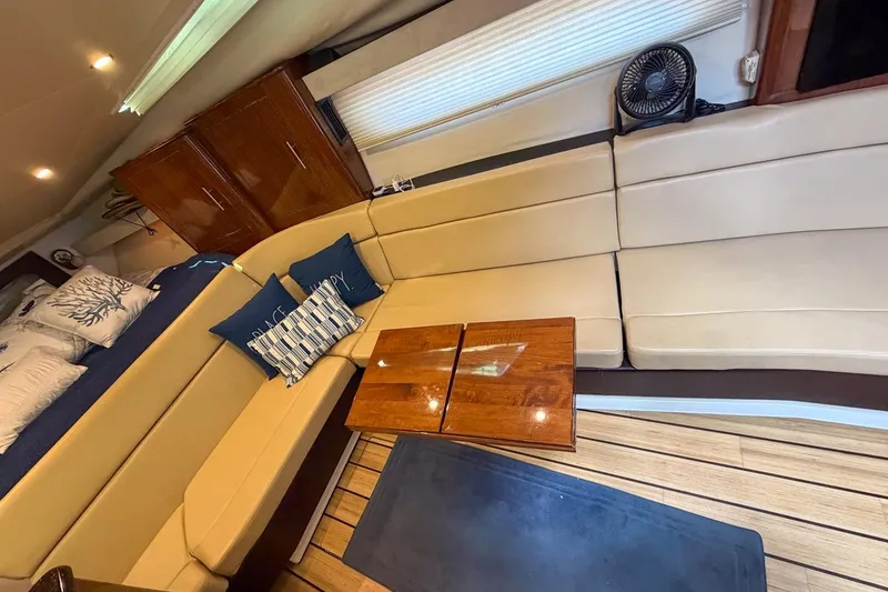 Slide: The Image of Luxurious interior of 2015 Regal 38 Express yacht with beige seating and wooden accents. - 84