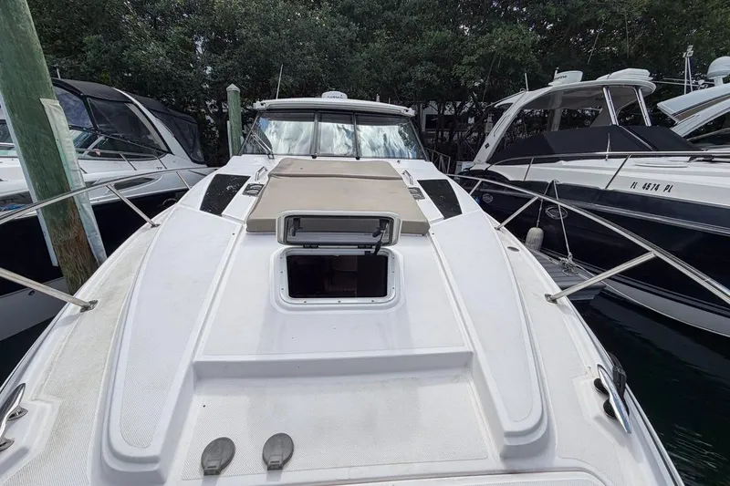 Slide: The Image of 2015 Regal 38 Express yacht docked among other boats, showcasing its sleek design. - 34