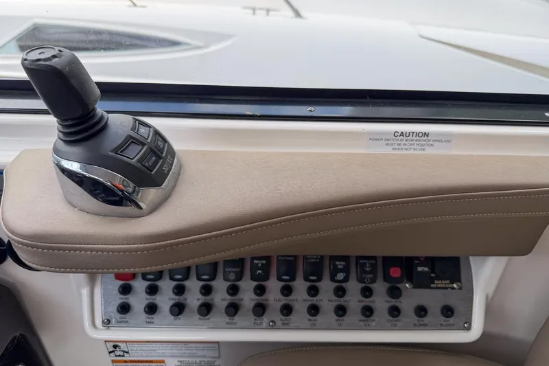 Slide: The Image of Control panel of a 2015 Regal 38 Express boat with joystick and switches. - 61
