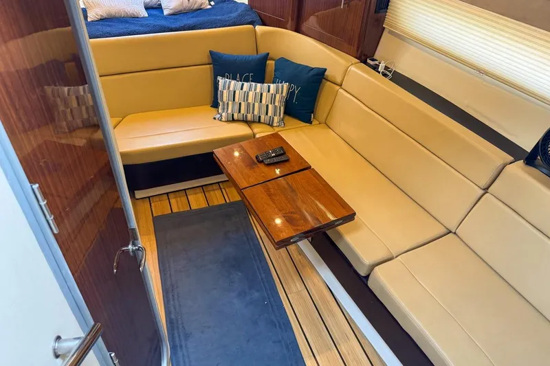 Slide: The Image of Luxurious interior of 2015 Regal 38 Express yacht with beige seating and wooden table. - 79