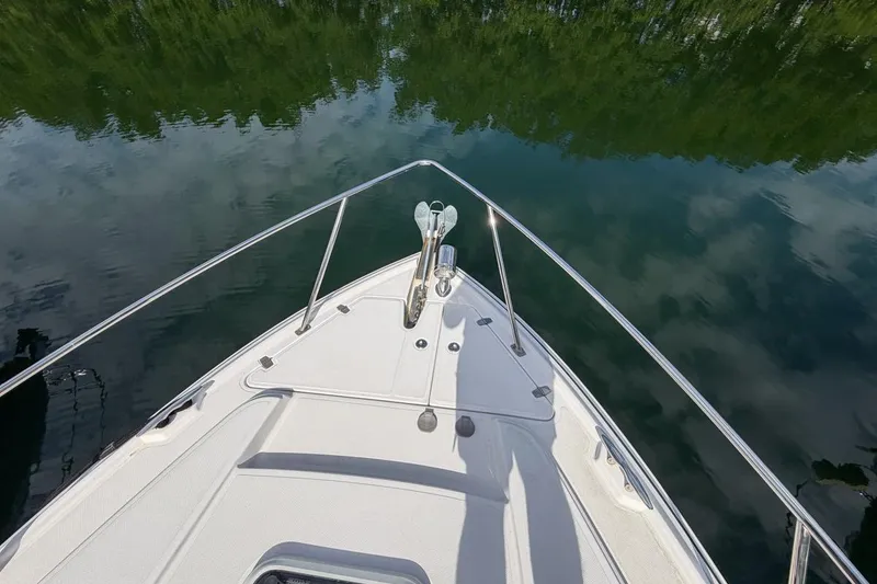 Slide: The Image of Bow view of 2015 Regal 38 Express boat on calm water. - 26