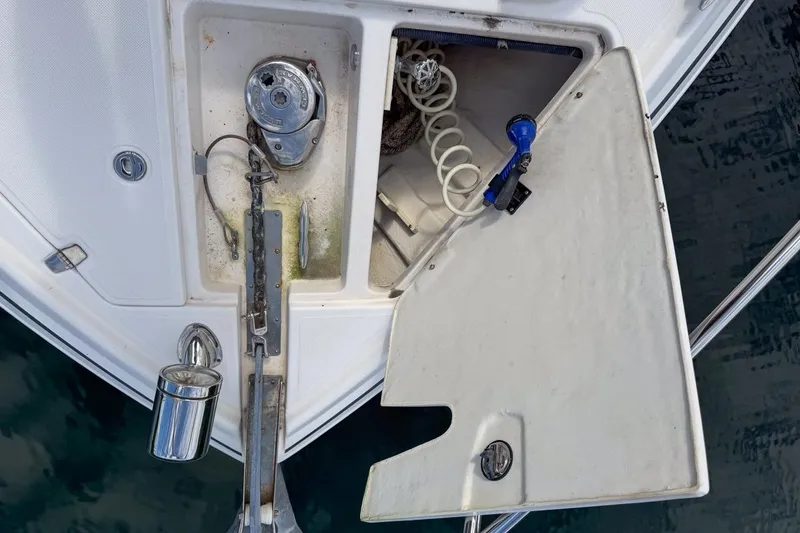 Slide: The Image of Open anchor locker on 2015 Regal 38 Express boat, showing anchor chain and storage. - 29