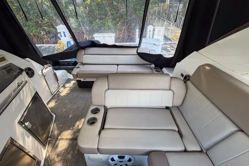 Slide: The Image of Interior of 2015 Regal 38 Express yacht with beige seating and cup holders. - 46