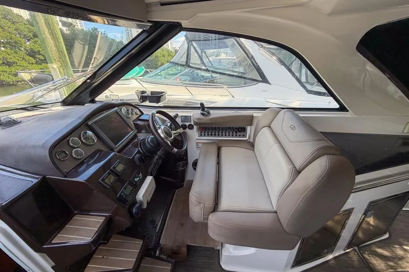 Slide: The Image of Interior cockpit of 2015 Regal 38 Express yacht with leather seating and control panel. - 63