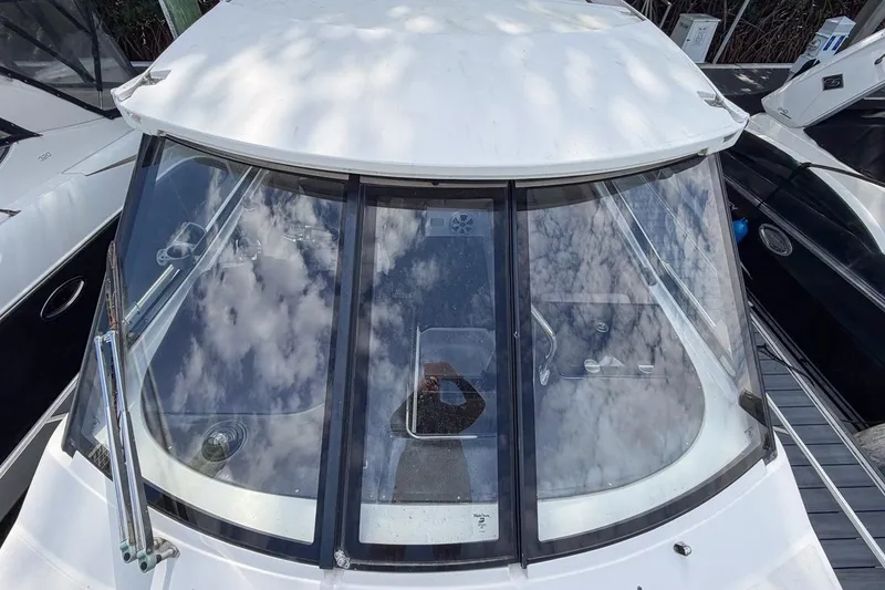 Slide: The Image of 2015 Regal 38 Express yacht with reflective windows and sleek design. - 43
