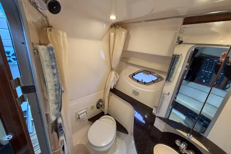 Slide: The Image of 2015 Regal 38 Express yacht bathroom with modern fixtures and porthole window. - 96