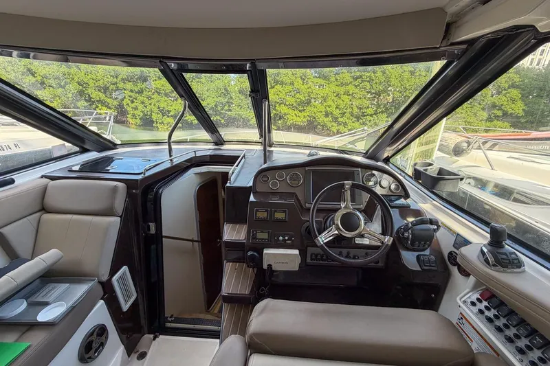 Slide: The Image of 2015 Regal 38 Express boat cockpit with steering wheel and control panel. - 21