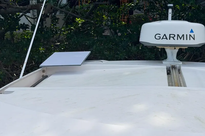 Slide: The Image of 2015 Regal 38 Express boat with Garmin radar and satellite dish on deck. - 44