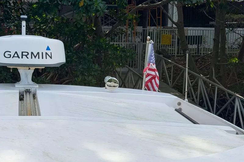 Slide: The Image of 2015 Regal 38 Express boat with Garmin radar and American flag. - 45