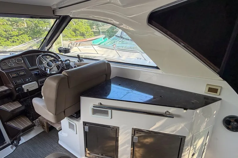 Slide: The Image of Interior of 2015 Regal 38 Express yacht cockpit with steering wheel and dashboard. - 67