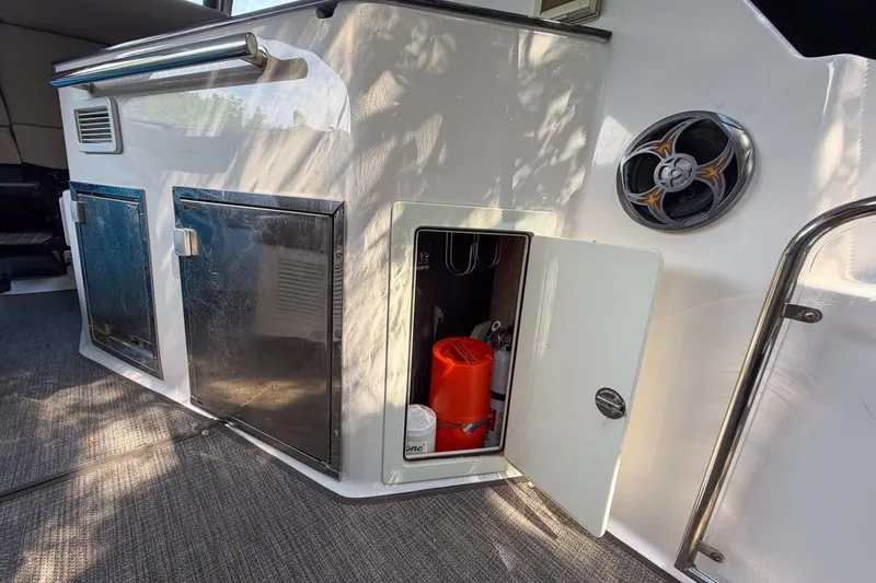 Slide: The Image of 2015 Regal 38 Express yacht interior storage compartment with open door and visible equipment. - 72