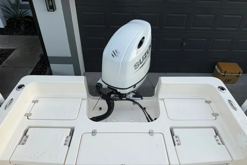 Slide: The Image of 2025 Bulls Bay 2200 XS boat with Suzuki outboard motor in driveway. - 14