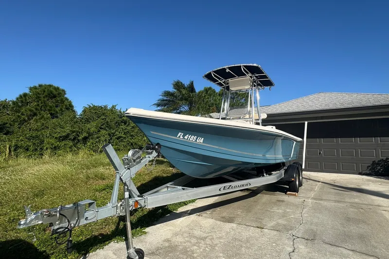 The Image of 2025 Bulls Bay 2200 XS boat on trailer, parked in driveway under clear blue sky. - 0