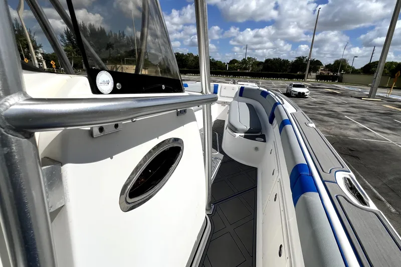 Slide: The Image of 2007 Wellcraft 35 Scarab Sport Open boat interior with blue accents under a cloudy sky. - 91