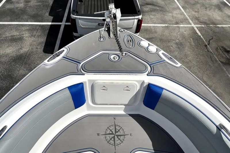 Slide: The Image of 2007 Wellcraft 35 Scarab Sport Open boat bow with compass design, parked in lot. - 100