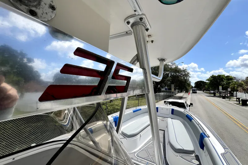 Slide: The Image of 2007 Wellcraft 35 Scarab Sport Open boat on a sunny street, showcasing sleek design. - 93