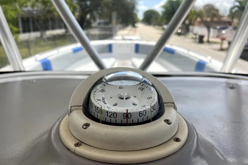 Slide: The Image of Compass on 2007 Wellcraft 35 Scarab Sport Open boat, with blurred outdoor background. - 67