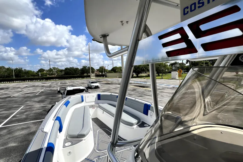 Slide: The Image of 2007 Wellcraft 35 Scarab Sport Open boat in parking lot under blue sky. - 88