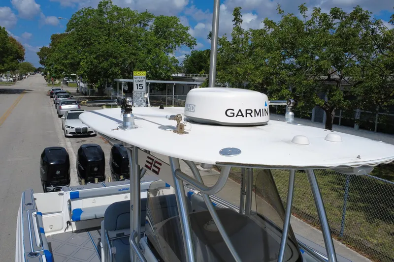 Slide: The Image of 2007 Wellcraft 35 Scarab Sport Open with Garmin radar, parked on a tree-lined street. - 114