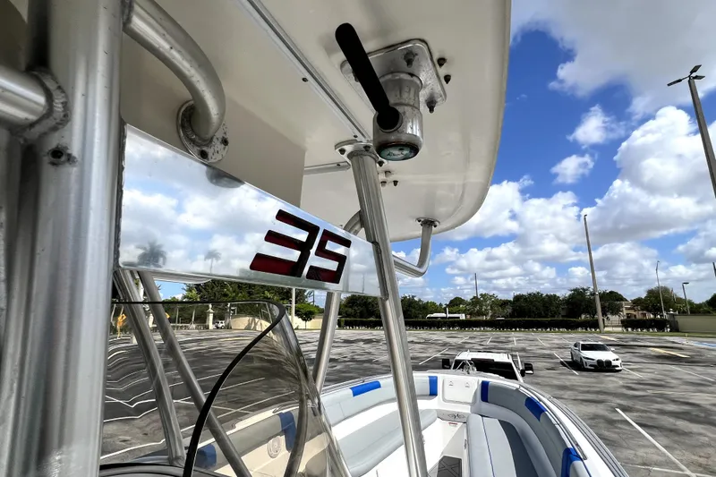 Slide: The Image of 2007 Wellcraft 35 Scarab Sport Open boat in parking lot under blue sky. - 92