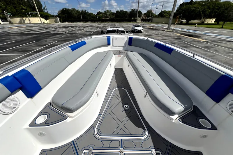 Slide: The Image of 2007 Wellcraft 35 Scarab Sport Open boat interior with gray and blue seating in a parking lot. - 107